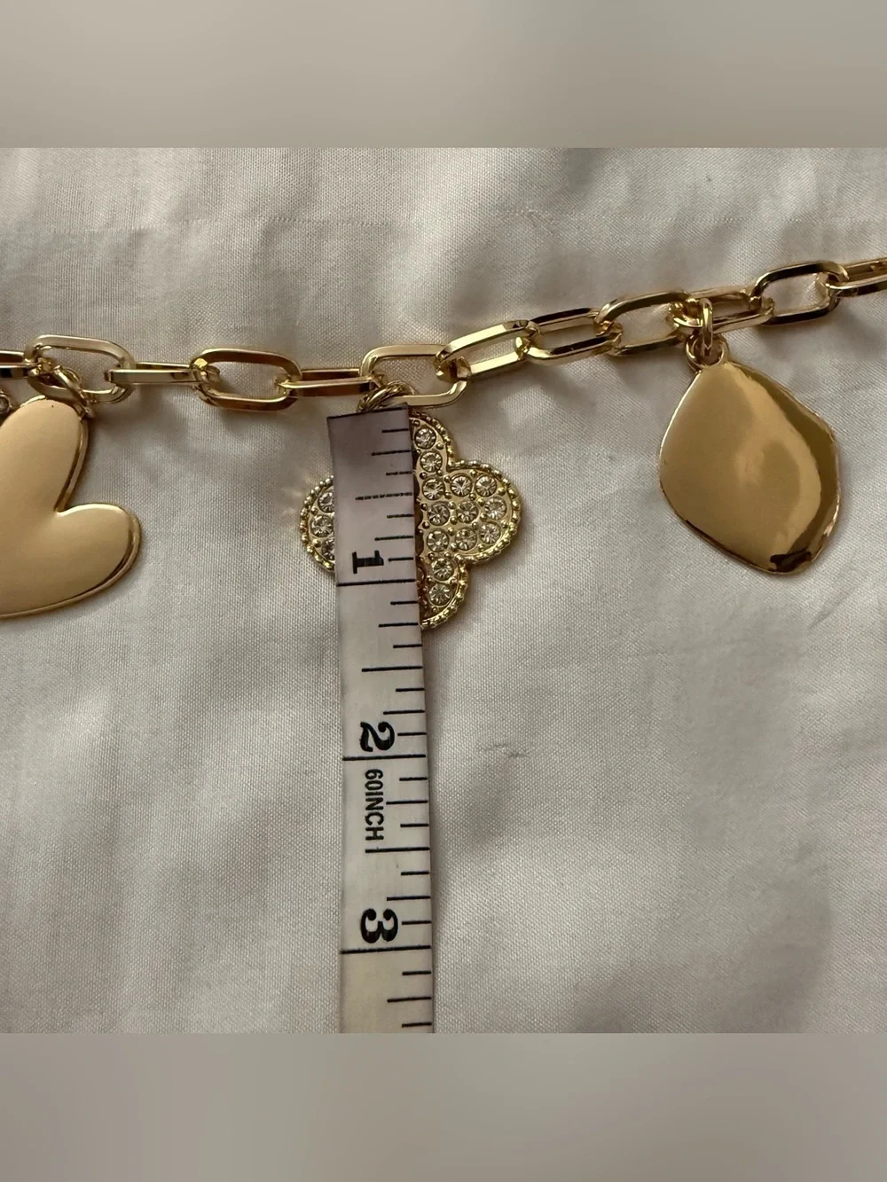 Gold tone metallic charms skinny chain belt